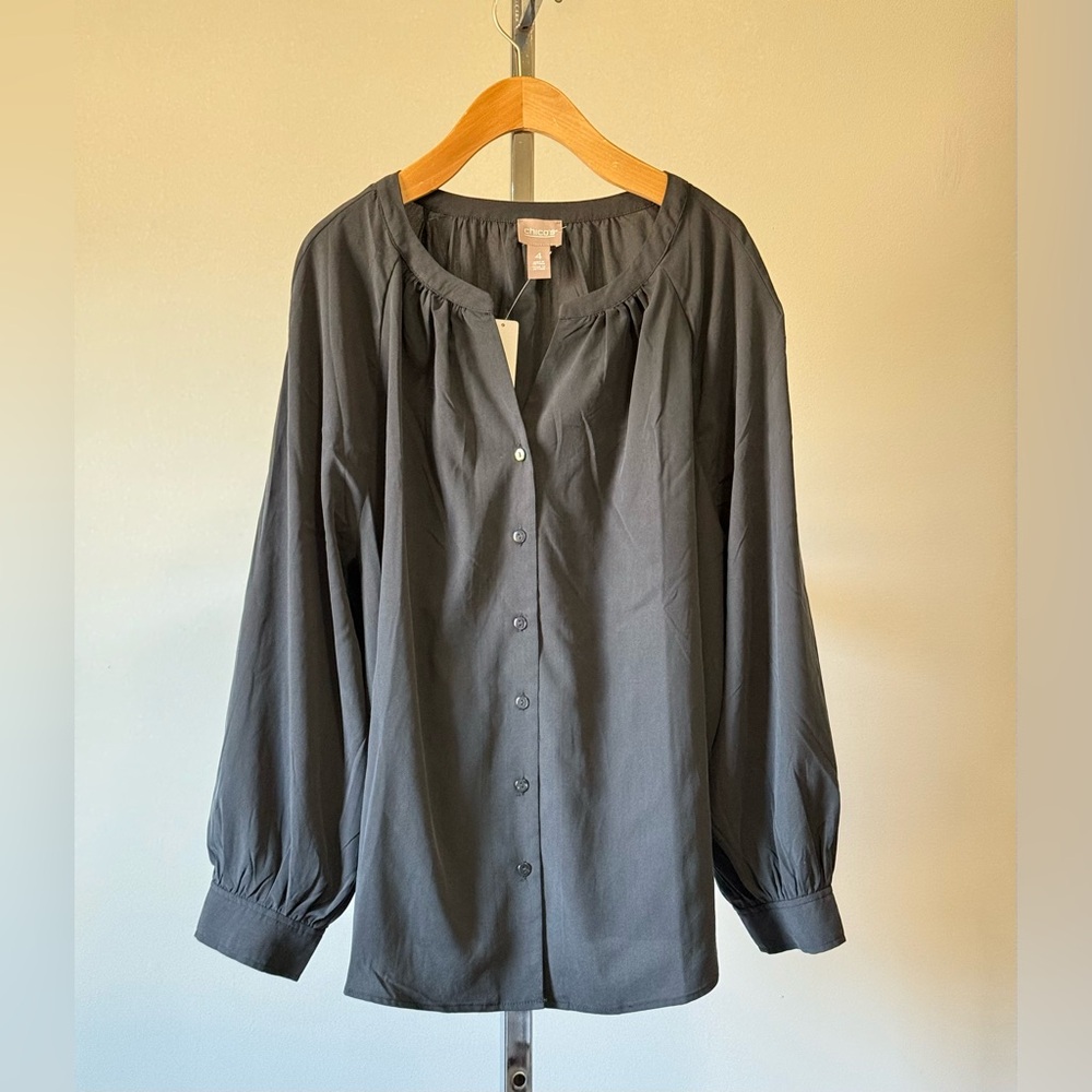 Long-sleeved blouse buttons on the front round neckline with gathered details. |